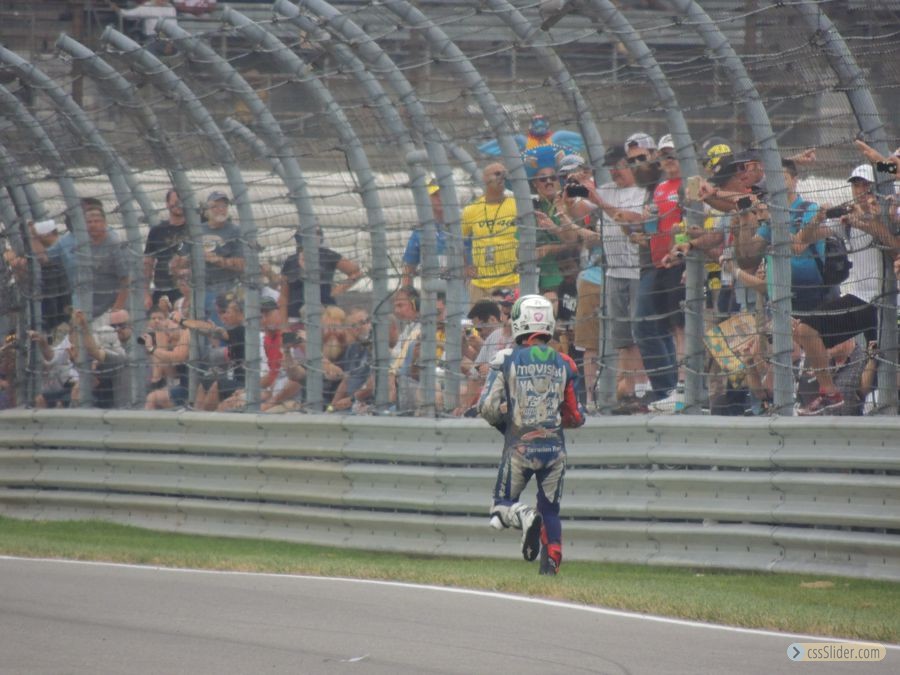 Lorenzo running down pit exit to get back to garage