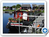 Boats docked along small canal