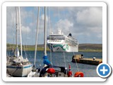 Yachts moored along pier